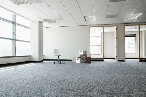 Empty office with boxes and one chair