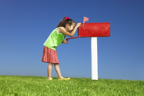 Girl looking inside mailbox
