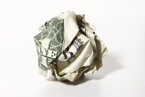 US dollar bill crumpled into a ball
