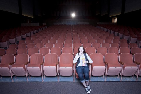 woman in empty movie theater
