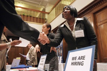 A job seeker shakes hands with a recruiter during the San Francisco Hirevent job fair at the Hotel Whitmore on July 12, 2011 in San Francisco, California.