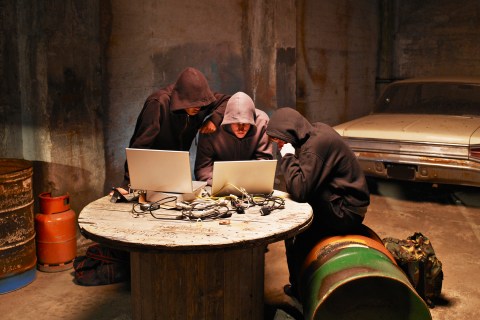 Hooded men on laptops