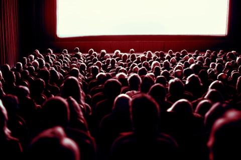 Crowd watching movie in theater