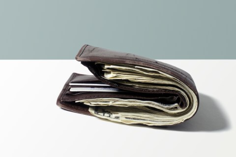 Bulging wallet filled with money