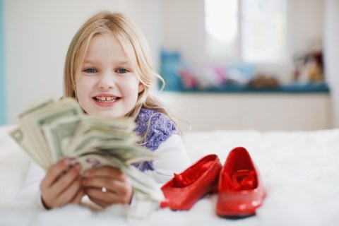 Smiling girl holding dollar bills