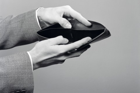 Man holding empty wallet