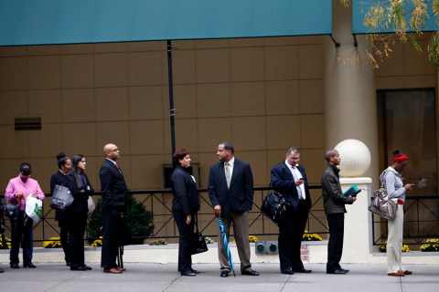 Job seekers stand in line to meet prospective employers at a career fair in New York City