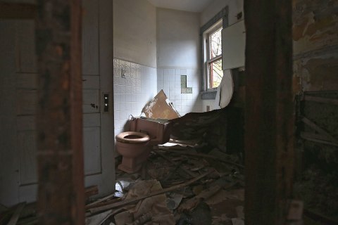 image: Bathroom walls are stripped of copper plumbing in a condemned house in Warren, Ohio, Oct. 28, 2012. 