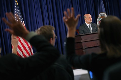 Reporters raise their hands to ask Federal Reserve Chairman Ben Bernanke a question during a press conference