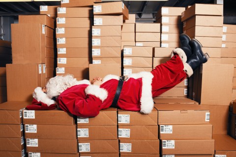 Santa sleeping on boxes