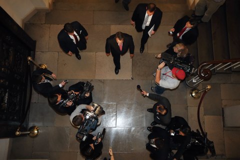 image: U.S. House Speaker John Boehner walks past journalists on his return to the U.S. Capitol after meeting with President Barack Obama at the White House in Washington, Dec. 13, 2012.