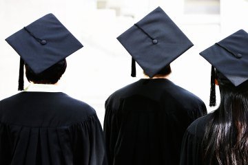 Rear view of students wearing graduation caps