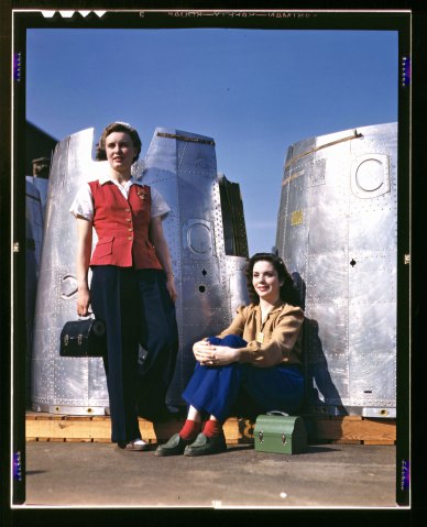 Two assembly line workers in front of bomber parts at the Douglas Aircraft Company plant in Long Beach, Calif., 1942.