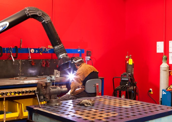 A man welds in the Google Workshops