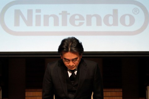 Nintendo Co President Iwata bows during their strategy and earnings briefings in Tokyo